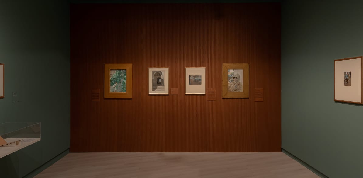 Dia Internacional dos Museus Sala de exposição com quatro obras emolduradas sobre parede de madeira em museu